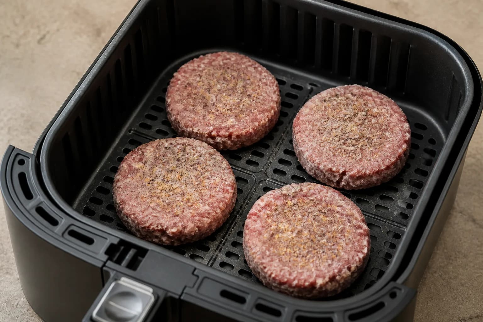 Air Fryer Frozen Burgers: How Long for ¼-lb and ⅓-lb Patties after step 2: Season the top side with salt, pepper, and garlic powder. If the patties are stuck together, run the sealed pack briefly under cool water just un