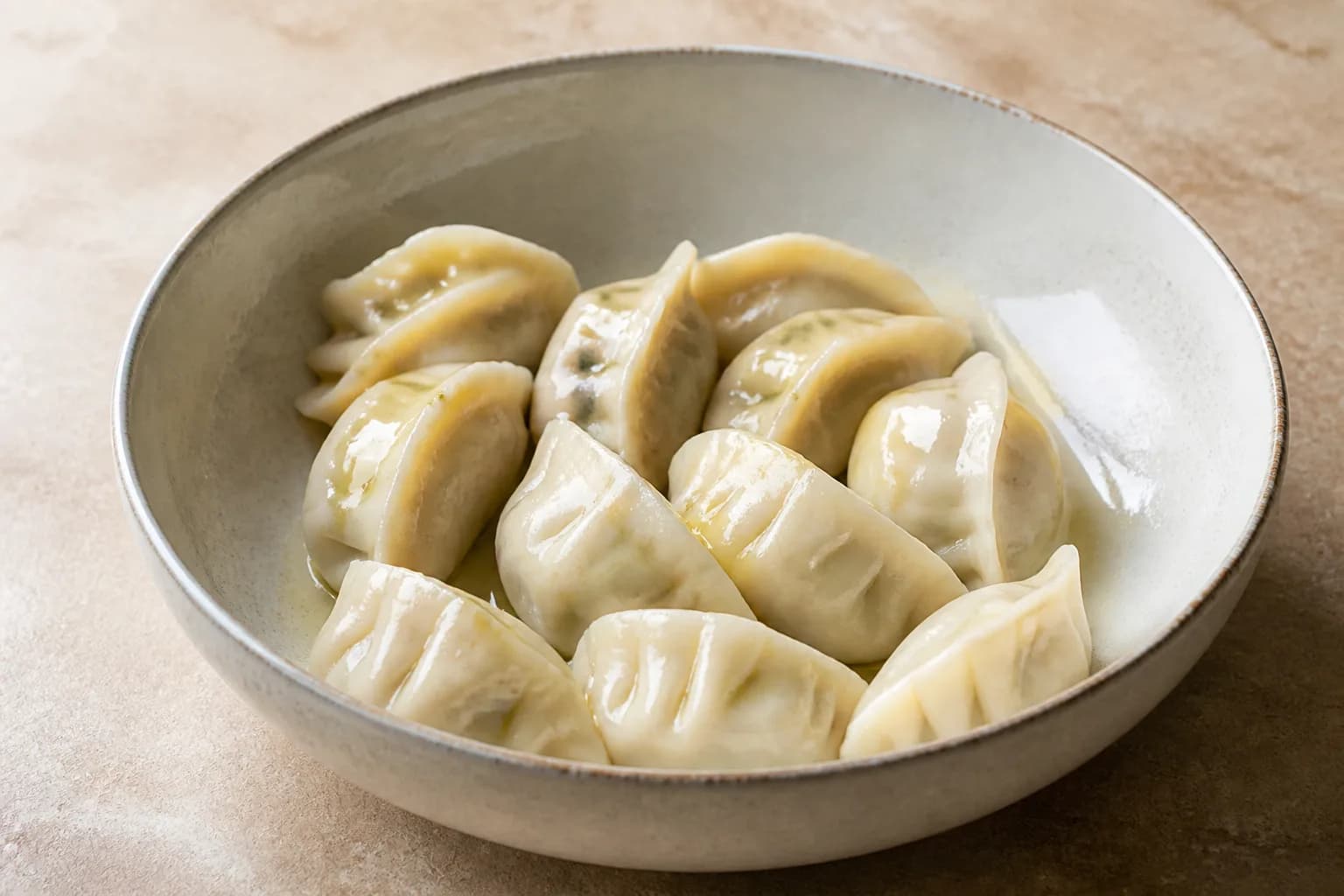 Air Fryer Frozen Dumplings: How Long for Potstickers, Gyoza, and Mandu after step 2: Place the frozen dumplings in a bowl and lightly spray or brush them with oil, coating the tops and sides. Do not thaw them first.